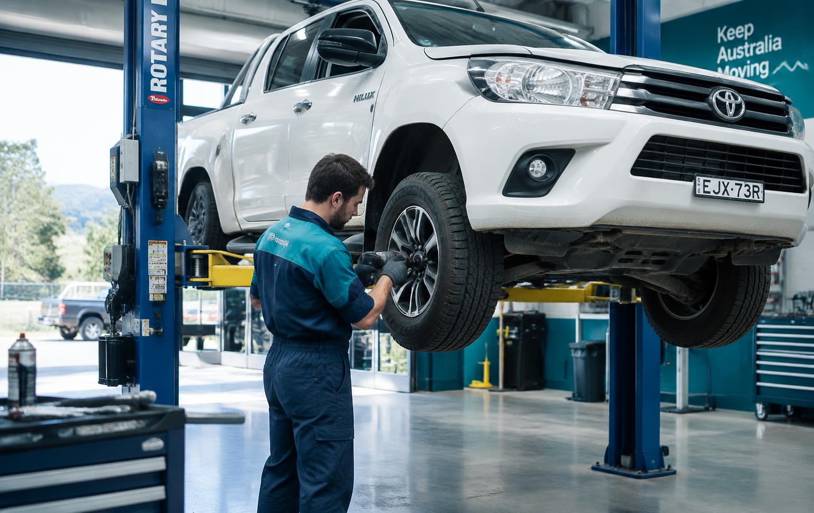 Mechanic servicing a Toyota Hilux on a hoist at All You Need Mechanics, Armadale WA
